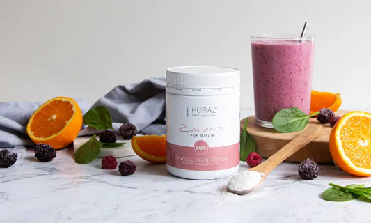 Unflavoured bovine collagen peptides powder beside a smoothie in a bright modern kitchen setting.
