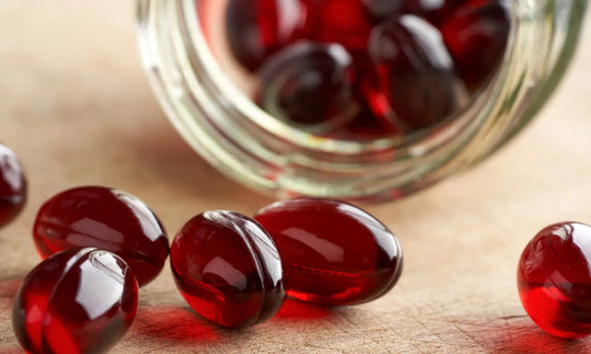 Person comparing krill oil and multivitamin labels beside breakfast before combining supplements