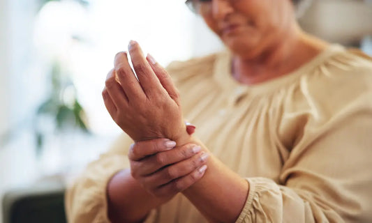New Zealand woman in midlife pausing after everyday movement while considering persistent joint aches