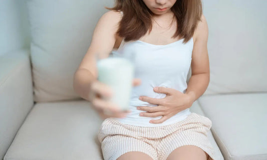 Probiotic powder scoop beside a meal-digestion label card and subtle gold kiwifruit, showing two gut-support pathways