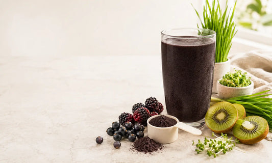 Peach superfood powder smoothie with blackcurrants, boysenberries, kiwifruit, greens and a supplement scoop for a collagen superfood routine
