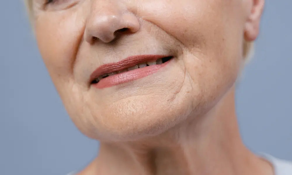 Midlife woman in a natural New Zealand wellness setting with collagen capsules for ageing skin support