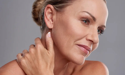 Woman with healthy natural skin in soft light representing skin longevity and long-term skin resilience