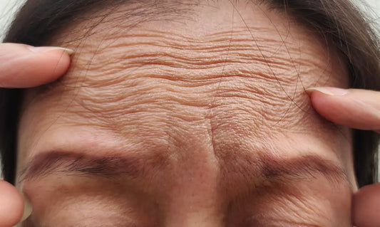 Confident New Zealand woman looking in a mirror in natural daylight with healthy, realistic skin