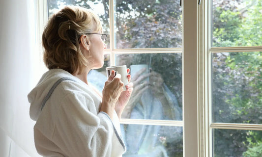 Woman in her forties reflecting on perimenopause and building supportive daily health foundations