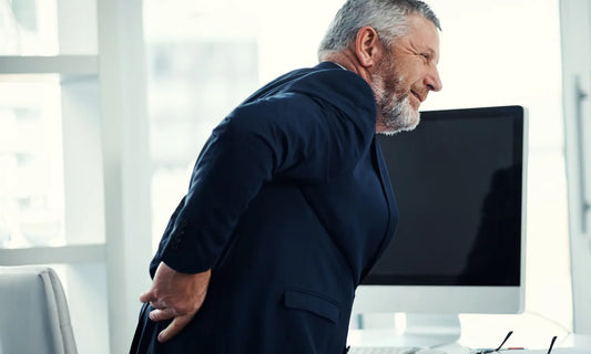 Person standing from a desk chair and gently moving after sitting to support joint mobility.